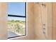 Bathroom with shower and window offering scenic views at 10648 E Greythorn Dr, Scottsdale, AZ 85262