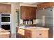 Modern kitchen island with granite countertops and stainless steel appliances at 10648 E Greythorn Dr, Scottsdale, AZ 85262