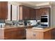 Spacious kitchen with dark wood cabinetry and granite countertops at 10648 E Greythorn Dr, Scottsdale, AZ 85262