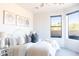 Bright bedroom with a queen-size bed and lots of natural light at 10648 E Greythorn Dr, Scottsdale, AZ 85262