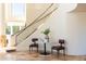 Modern staircase with glass railings and a marble-top table at 10648 E Greythorn Dr, Scottsdale, AZ 85262