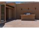 Outdoor kitchen area with built-in grill and bar at 10648 E Greythorn Dr, Scottsdale, AZ 85262