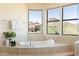 Spa-like bathroom featuring a large soaking tub and views at 10648 E Greythorn Dr, Scottsdale, AZ 85262