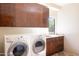 Laundry room with washer, dryer, and ample cabinetry at 10648 E Greythorn Dr, Scottsdale, AZ 85262