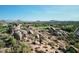 Aerial view of community with large rock formations and homes at 10648 E Greythorn Dr, Scottsdale, AZ 85262