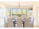 Elegant dining room with large windows and seating for eight at 10648 E Greythorn Dr, Scottsdale, AZ 85262