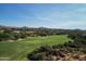 Aerial view showcases a stunning golf course and mountain views at 10648 E Greythorn Dr, Scottsdale, AZ 85262