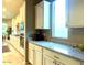Kitchen features white cabinets, granite countertops, and an abundance of storage at 27002 W Oraibi Dr, Buckeye, AZ 85396
