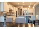 Modern kitchen with an island, white cabinets, stainless steel appliances, and granite countertops at 27002 W Oraibi Dr, Buckeye, AZ 85396