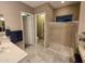 Bathroom with walk-in shower, vanity with double sinks, and separate toilet area at 27002 W Oraibi Dr, Buckeye, AZ 85396