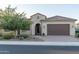 Charming house with a welcoming front entry and well-maintained landscaping at 27002 W Oraibi Dr, Buckeye, AZ 85396