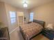 Bedroom with queen bed and en-suite bathroom at 27002 W Oraibi Dr, Buckeye, AZ 85396