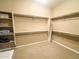 Large walk-in closet featuring double hanging rods and shelves at 27002 W Oraibi Dr, Buckeye, AZ 85396