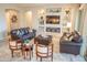 Comfortable living room with built-in shelving, a large TV, and two brown sofas at 27002 W Oraibi Dr, Buckeye, AZ 85396