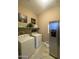 Laundry room with washer, dryer, and refrigerator at 27002 W Oraibi Dr, Buckeye, AZ 85396