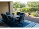 Patio with table and chairs, blue rug, and view of backyard at 27002 W Oraibi Dr, Buckeye, AZ 85396