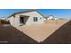 Spacious backyard with gravel and a covered patio at 17383 W El Caminito Dr, Waddell, AZ 85355