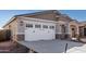 Front view of a house with a two-car garage at 17383 W El Caminito Dr, Waddell, AZ 85355