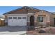 Single-story home with white garage door and landscaping at 17383 W El Caminito Dr, Waddell, AZ 85355