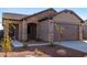 Single-story home with stone accents and two-car garage at 17389 W El Caminito Dr, Waddell, AZ 85355