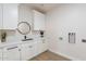 Laundry room with white cabinets, quartz countertop, and built-in sink at 3939 S Veronica Ln, Gold Canyon, AZ 85118