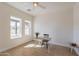 Bright bedroom with wood floors, desk, and two windows at 3939 S Veronica Ln, Gold Canyon, AZ 85118