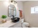 Stylish bathroom featuring a black vessel sink and arched mirror at 3939 S Veronica Ln, Gold Canyon, AZ 85118