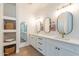 Modern bathroom with double vanity, white cabinets, and oval mirrors at 3939 S Veronica Ln, Gold Canyon, AZ 85118