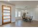 Bright dining room with wood table and black chairs, wood floors, and modern light fixtures at 3939 S Veronica Ln, Gold Canyon, AZ 85118