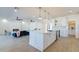 View of kitchen island and living room with fireplace and modern decor at 3939 S Veronica Ln, Gold Canyon, AZ 85118