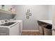Bright laundry room with washer, dryer, and folding counter at 10737 E Simone Ave, Mesa, AZ 85212