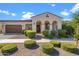 Tan colored house with arched entry and two car garage at 10737 E Simone Ave, Mesa, AZ 85212