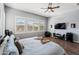 Main bedroom with large windows, TV mount, and sitting area at 10737 E Simone Ave, Mesa, AZ 85212