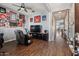 Bright living room featuring hardwood floors and a large TV at 10737 E Simone Ave, Mesa, AZ 85212