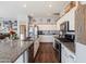 Modern kitchen with white cabinets and granite countertops at 10737 E Simone Ave, Mesa, AZ 85212