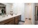 Bathroom with double sinks, vanity, and walk-in shower at 16543 W Alameda Rd, Surprise, AZ 85387
