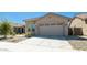Tan house with a two car garage and landscaping at 16543 W Alameda Rd, Surprise, AZ 85387