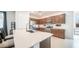 Kitchen boasts modern cabinetry, quartz countertops, and stainless steel appliances at 16543 W Alameda Rd, Surprise, AZ 85387