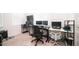 Home office with multiple monitors and comfortable seating at 16543 W Alameda Rd, Surprise, AZ 85387