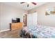 Bedroom with double doors leading to bathroom, featuring a ceiling fan at 3630 N 372Nd Ln, Tonopah, AZ 85354