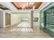 Bright dining room with hardwood floors, a modern chandelier, and a glass wine cellar at 31010 N 117Th Dr, Peoria, AZ 85383