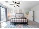 Spacious bedroom with a metal bed frame, ceiling fan, and access to a balcony at 142 E Hearne Way, Gilbert, AZ 85234