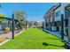 Landscaped grassy area with string lights and modern buildings at 142 E Hearne Way, Gilbert, AZ 85234