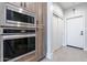 Built-in oven and microwave, along with a white door and sliding doors at 142 E Hearne Way, Gilbert, AZ 85234