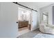 Modern bathroom with double sinks, wood cabinets, and a walk-in shower at 142 E Hearne Way, Gilbert, AZ 85234