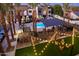 Evening view of community pool, courtyard with string lights at 142 E Hearne Way, Gilbert, AZ 85234