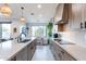 Modern kitchen with wood cabinets, stainless steel appliances, and an island at 142 E Hearne Way, Gilbert, AZ 85234