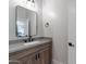 Simple bathroom with a single sink and wood cabinet at 142 E Hearne Way, Gilbert, AZ 85234