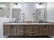 Spa-like bathroom with double vanity and a large mirror at 142 E Hearne Way, Gilbert, AZ 85234