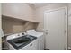 Laundry room with washer, dryer, and overhead shelving at 1448 E Poncho Ln, San Tan Valley, AZ 85143